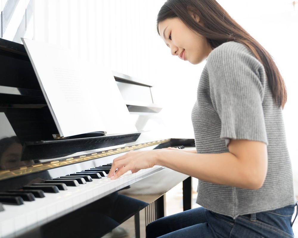 Portrait Asian woman playing  playing piano